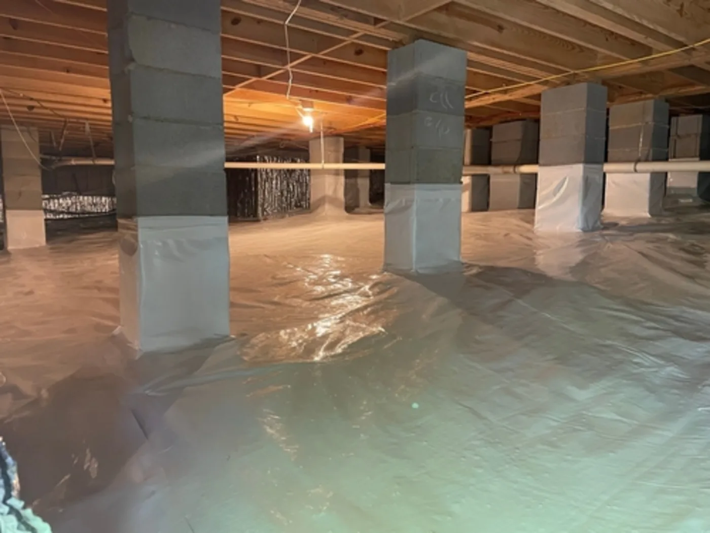 Hampton Roads crawl space after cleanout, with contaminated material removed and a fresh vapor barrier laid over the soil